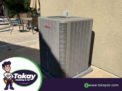 Exterior view of a house featuring a air conditioner